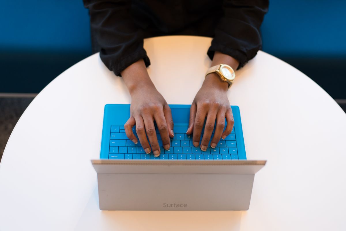 Person typing a response on a laptop